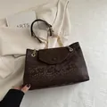 Deep brown snake skin embossed tote bag with gold chain strap and flap closure - Brown
