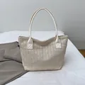 Beige woven straw bucket bag with white faux leather handles for summer beach style - White