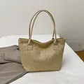 Beige woven bucket tote bag with leather straps for beach holidays and summer travel - Khaki