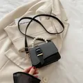 Mini black textured PU crossbody bag featuring a pearl handle and chic metal buckle - Black