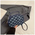 Close-up of blue and white plaid fabric texture on a stylish leather handbag - Dark Blue