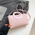Light pink handbag with circle handle and monogram pattern in textured leather - Pink