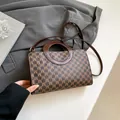 Brown handbag with M-pattern monogram and unique circular handle in elegant brown finish - Brown