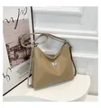Khaki croc-embossed shoulder bag with silver butterfly charm on a white pedestal - Khaki