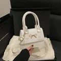 White leather handbag with gold bow clasp on silk lining and gift box - White