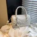 White snakeskin textured bowling handbag with pearl bow and heart charm detail - With Pendant / White