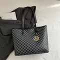 Deep grey tote bag with M-letter print and gold metal logo pendant on a suit jacket - Black