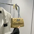 Champagne gold quilted shoulder bag with metal butterfly clasp and chain strap - Gold