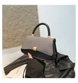 Detail of elegant two-tone handbag featuring grey fabric flap and black leather finish - Black