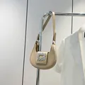 Elegant beige crescent shoulder bag featuring a sparkling crystal rectangle buckle detail - Khaki