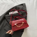 Red crocodile embossed box bag with gold chain strap and top handle design - Red