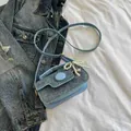 Light blue mini crossbody bag featuring pearl bow charm and denim texture finish - Blue with Pendant