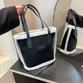Fashionable black tote bag with white faux shearling trim and leather handles - No Pendant / Black