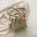 Sage green crossbody bucket bag with textured leather, silk scarf handle, and plush charm - With Pendant / Green