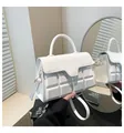 Detail of white crossbody bag featuring embossed chocolate block texture and top handle - White