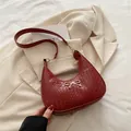 Burgundy woven shoulder bag with gold bow ornament and matching leather strap - Red