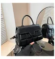 Detail of black glossy faux leather handbag with 3D chocolate quilted pattern - Black