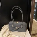 Textured dark gray pillow bag with gold hardware and stylish long shoulder straps - Black