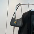 Chic black sequin underarm bag for women with golden twist lock and sleek crescent design - Black
