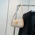 Beige shimmer woven shoulder bag with golden twist lock and slim leather strap - Khaki