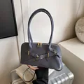 Dark blue woven Boston pillow bag with golden hardware and adjustable strap - Blue