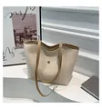 Detail view of cream tote bag with brown trim contrast and magnetic snap pocket - White