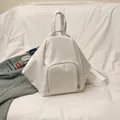 Pentagon shaped white PU leather backpack with a front zipper pocket for daily commute - White