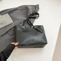 Minimalist black leather large tote bag for women with gold buckles and fashion text - Black