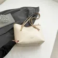 Creamy white tote bag with light brown adjustable straps and premium leather texture - Off White