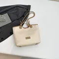 Minimalist cream white tote bag with brown trim and long handles for stylish commuting - White
