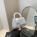 Elegant silver glitter mini handbag with pearl handle and golden chain strap for women - Silver