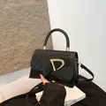 Sparkly black sequin crossbody bag with gold D-buckle and detachable shoulder strap - Black