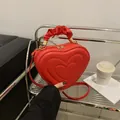 Red heart shaped handbag with quilted pattern and ruched cloud handle and gold zipper - Red