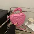 Pink heart-shaped PU leather crossbody bag with pleated handle and gold hardware - Pink