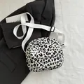 Chic black and white leopard print canvas crossbody bag with adjustable wide strap - White