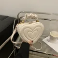 Vintage heart-shaped crossbody bag in creamy white with cloud pleated handle and gold hardware - White