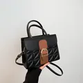 Black and brown leather handbag with gold D-ring buckle and quilted pattern details - Black