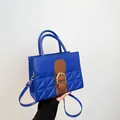 Royal blue quilted handbag with brown leather straps and gold buckle detail - Blue