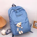 Minimalist blue school backpack with plush bear pendant and OUDLOVE LUCK text print - Blue