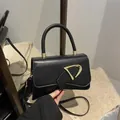Minimalist black square handbag with gold metal buckle and detachable shoulder strap - Black