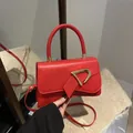 Elegant red square handbag with golden D-shaped buckle and adjustable shoulder strap - Red