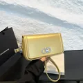 Chic golden leather underarm bag with silver metal buckle and elegant chain strap - Gold