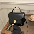Strukturierte schwarze Handtasche mit goldenem Drehverschluss und Schultergurt für Damen - Schwarz