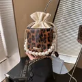 Leopard print bucket bag with pearl handle and golden chain strap in a stylish square shape - Brown