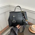 Elegant black PU backpack for women with gold hardware and embossed lettering detail - With Pendant / Black