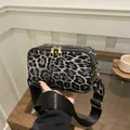Crossbody camera bag with gray leopard print pattern and adjustable wide black shoulder strap - Black