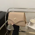 Minimalist beige crossbody square bag with gold oval twist lock and adjustable strap - Khaki