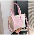 Détail du sac seau en nylon contrasté avec broderie rose et fermeture à glissière - Rose
