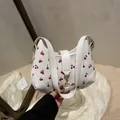 White shoulder bag with cute red cherry print and golden metal buckle clasp closure - White