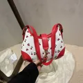 Red and white handbag with cherry print, featuring a golden metal buckle closure - Red
